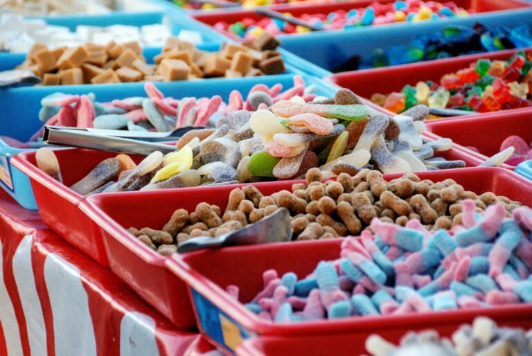 assorted-color sweet treats in red and blue plastic trays